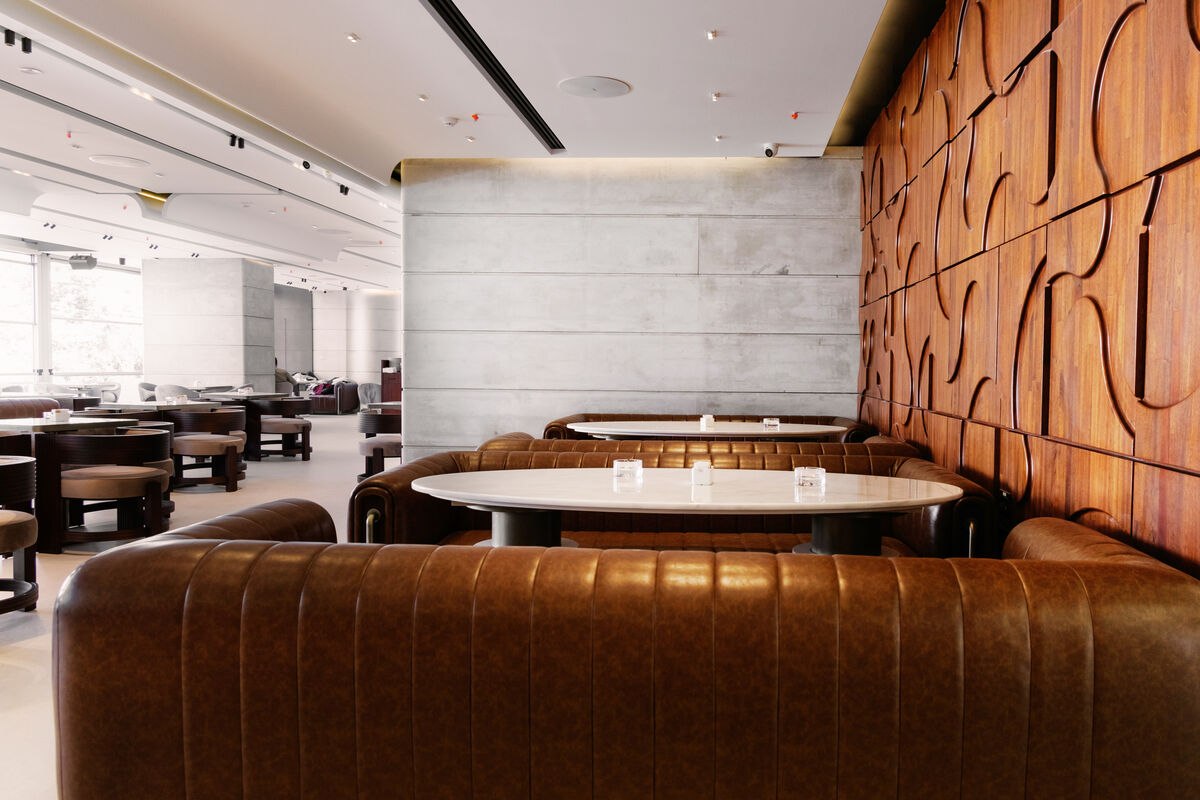 Leather booths beneath the sculptural carved wall